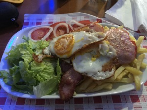 My dinner tonight 2 eggs 4 pieces of bacon 2 cuts of pork lots of fries and salad cost 7.50e